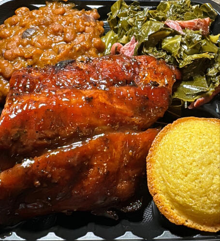 BBQ Pork Ribs, Baked Beans, Greens with smoked turkey, and cornbread.